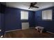 This bedroom features a ceiling fan and blue walls at 3302 Eisenhower Dr, Holiday, FL 34691