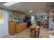 Bright kitchen area featuring wooden cabinets, stainless appliances, and a connected dining space at 3302 Eisenhower Dr, Holiday, FL 34691