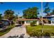 Charming single-story home featuring a front lawn, palm tree and driveway at 4126 Carson Ne St, St Petersburg, FL 33703