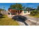 Tan single story home, long driveway and covered porch at 4126 Carson Ne St, St Petersburg, FL 33703
