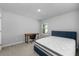 Bright bedroom with a desk, plush carpeting, a large window, and a comfortable bed at 4236 Cloud Hopper Way, Lutz, FL 33559