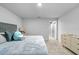 Cozy bedroom featuring plush carpet, a comfortable bed, and a modern chest of drawers at 4236 Cloud Hopper Way, Lutz, FL 33559