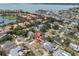Expansive aerial view of a single-Gathering home with an orange roof, complemented by a refreshing pool and lush greenery at 4395 50Th S Ter, St Petersburg, FL 33711