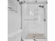 Clean, bright, white bathroom featuring a glass shower, updated fixtures, and tiled walls at 4395 50Th S Ter, St Petersburg, FL 33711