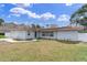 Charming single-story home with a red tile roof, solar panels, and a well-manicured lawn at 4395 50Th S Ter, St Petersburg, FL 33711