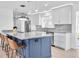 Modern kitchen with blue island, marble countertops, stainless steel appliances, and pendant lighting at 4395 50Th S Ter, St Petersburg, FL 33711