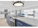 Open-concept kitchen with a marble countertop island, stainless steel appliances, and bright living space at 4395 50Th S Ter, St Petersburg, FL 33711