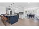 Modern kitchen with blue island, marble countertops, stainless steel appliances, and pendant lighting at 4395 50Th S Ter, St Petersburg, FL 33711