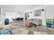 Open-concept living and dining area with tile floors, modern furniture, and bright windows at 4395 50Th S Ter, St Petersburg, FL 33711