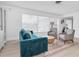 Bright living room featuring a comfortable sofa, modern chairs, and a stylish rug at 4395 50Th S Ter, St Petersburg, FL 33711