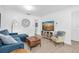 Bright living room features neutral paint, hardwood floors, modern furniture, and a television at 4395 50Th S Ter, St Petersburg, FL 33711
