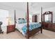 Main bedroom boasts a four-poster bed, wooden furniture, and soothing neutral color palette at 4395 50Th S Ter, St Petersburg, FL 33711