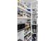 Organized walk-in pantry with adjustable shelving, food containers, a microwave, and small appliances at 4395 50Th S Ter, St Petersburg, FL 33711