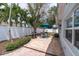 A backyard patio features a grill, dining set, and well-maintained landscaping at 4395 50Th S Ter, St Petersburg, FL 33711
