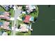 Bird's eye view of waterfront homes with private pools and docks, showcasing lush landscaping and neighborhood streets at 4804 Longwater Way, Tampa, FL 33615