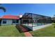 View of the waterfront home with a screened pool and spacious backyard at 4804 Longwater Way, Tampa, FL 33615