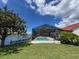 The backyard features a screened pool with a dock and waterfront views at 4804 Longwater Way, Tampa, FL 33615