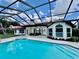 Home features a screened pool, hot tub and backyard patio overlooking a waterway at 4804 Longwater Way, Tampa, FL 33615