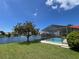 Backyard shot showcasing waterfront view and screened pool at 4804 Longwater Way, Tampa, FL 33615