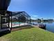 Waterfront home with a screened pool, dock, and beautifully landscaped yard at 4804 Longwater Way, Tampa, FL 33615