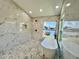 The bathtub is the focal point of this bathroom with marble-look tile, a shower, and hexagon tile flooring at 4804 Longwater Way, Tampa, FL 33615