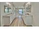 Modern bathroom with double vanities, lake views, and decorative lighting at 4804 Longwater Way, Tampa, FL 33615