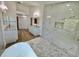 Spacious bathroom with walk-in shower, soaking tub, dual vanities, wood-look floors and marble-look tile at 4804 Longwater Way, Tampa, FL 33615