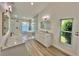 Bright bathroom with double vanities, lake views, and a soaking tub at 4804 Longwater Way, Tampa, FL 33615