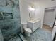 Stylish bathroom with tiled shower, hexagon tile floors, and modern vanity at 4804 Longwater Way, Tampa, FL 33615