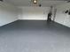 View of the spacious garage featuring an epoxy floor and ample room for storage at 4804 Longwater Way, Tampa, FL 33615