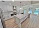 Modern kitchen featuring marble countertops, stainless appliances and open view of dining area at 4804 Longwater Way, Tampa, FL 33615