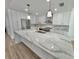 Modern kitchen boasts an oversized island with a waterfall edge and stylish gold fixtures at 4804 Longwater Way, Tampa, FL 33615