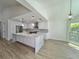 Bright, modern kitchen features a large island with seating and views into the dining area at 4804 Longwater Way, Tampa, FL 33615