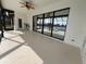 Spacious lanai with stamped concrete floor, ceiling fan, and sliding doors overlooking pool and waterway at 4804 Longwater Way, Tampa, FL 33615
