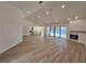 Open-concept living space with vaulted ceilings, wood-look tile flooring, a modern fireplace, and pool views at 4804 Longwater Way, Tampa, FL 33615