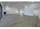 Vaulted ceiling living room leading into a modern kitchen and offering views of an outdoor pool at 4804 Longwater Way, Tampa, FL 33615