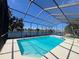 Waterfront screened pool offers a hot tub and clear blue water and beautiful scenery at 4804 Longwater Way, Tampa, FL 33615