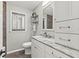 Stylish bathroom featuring marble vanity, toilet, and decorative tile at 522 James St, Dunedin, FL 34698