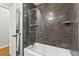Bathroom featuring tiled walls, glass shower and towel rack, a modern and stylish space at 522 James St, Dunedin, FL 34698