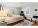 Bright bedroom with hardwood floors, ceiling fan, and ample natural light at 522 James St, Dunedin, FL 34698