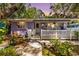 Charming purple home with manicured landscaping and a cozy front porch at 522 James St, Dunedin, FL 34698