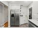 Spacious kitchen featuring stainless steel refrigerator, white cabinets and marble countertops at 522 James St, Dunedin, FL 34698