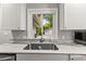 Close up of the sink and marble countertop in the kitchen at 522 James St, Dunedin, FL 34698