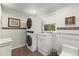 Modern laundry room with stackable washer/dryer, window and mosaic tile accents at 522 James St, Dunedin, FL 34698