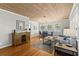 Stylish living room with hardwood floors and a rustic wood accent wall at 522 James St, Dunedin, FL 34698