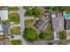 Aerial view showcasing the home's position on a tree-lined street with generous yard space at 5995 59Th N Way, St Petersburg, FL 33709