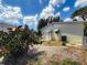 A view of the back of the home with beautiful blue sky and lush trees at 5995 59Th N Way, St Petersburg, FL 33709