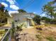 Backyard area with a chain-link fence, patio, and lush greenery at 5995 59Th N Way, St Petersburg, FL 33709