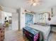 Bright bedroom features a decorative trunk, unique wall art, and a ceiling fan at 5995 59Th N Way, St Petersburg, FL 33709