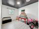 Cozy bedroom with playful star ceiling, dollhouse, and toy car at 5995 59Th N Way, St Petersburg, FL 33709